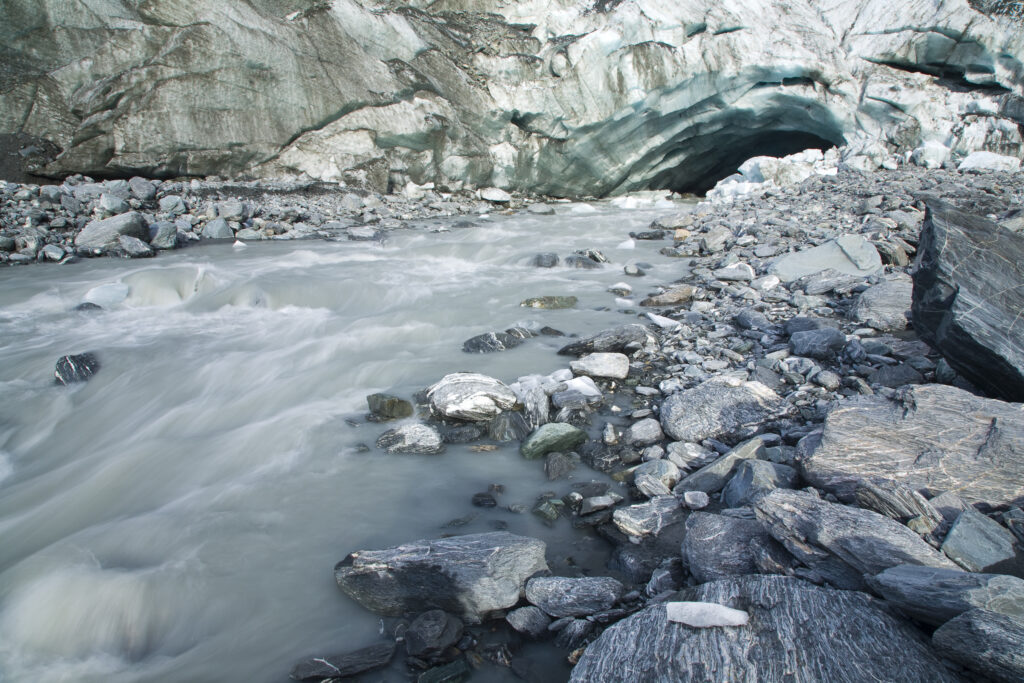 NEW ZEALAND, Westland, Westland National Park. Glacial river and glacial deposited rocks downstream of the Franz Josef Glacier.