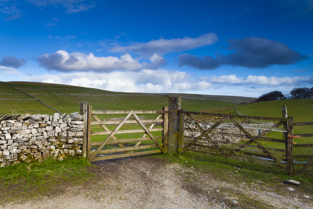 England, North Yorkshire, Yorkshire Dales National Park. Farm field and wooden gates, near the small village of Horton in Ribblesdale.