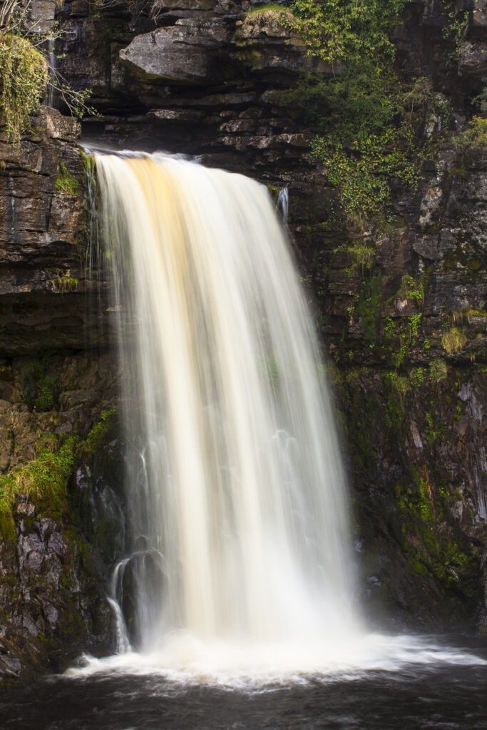 England, North Yorkshire, Ingleton. The fast flowing waters of the Thornton Force waterfall near Ingleton near the Yorkshire Dales National Park.