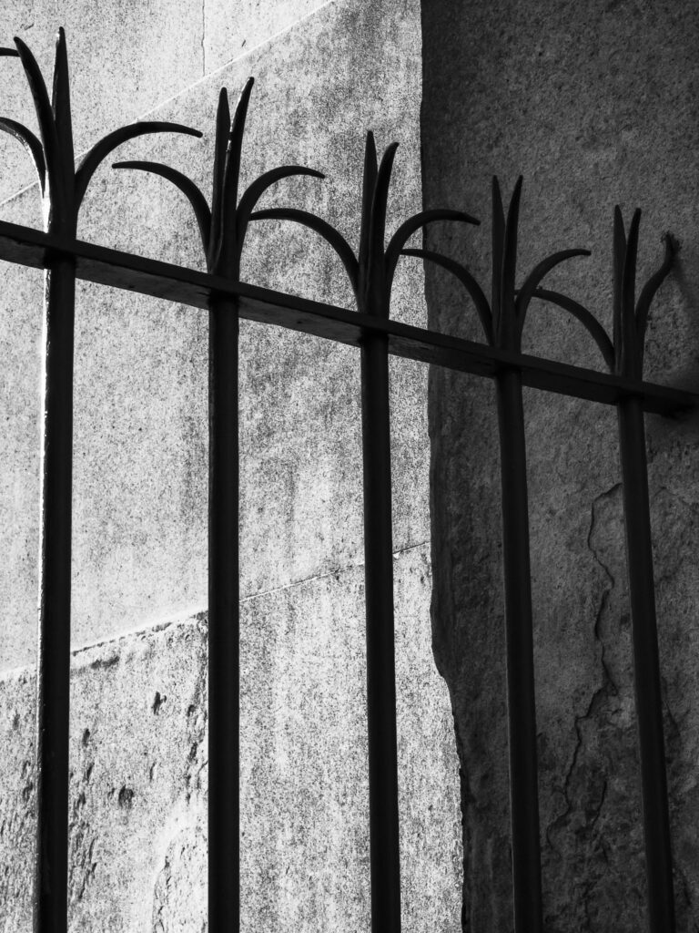 England, London, Hyde Park Corner. Detail shot of metal railings against stone pillar at Hyde Park Corner in London.