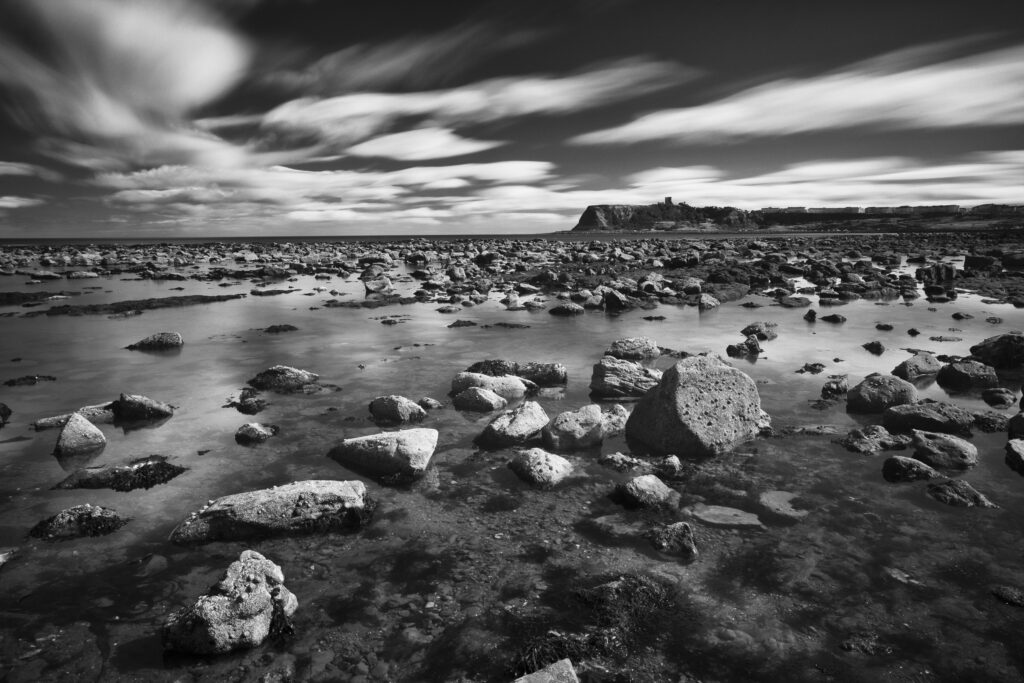 England, North Yorkshire, Scarborough. Scarborough North Bay at low tide, with Scarborough Castle in the distance.