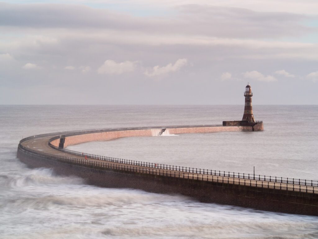 England, Tyne and Wear, Roker Pier. Roker Pier and Lighthouse located at the mouth of the River Wear in the city of Sunderland.