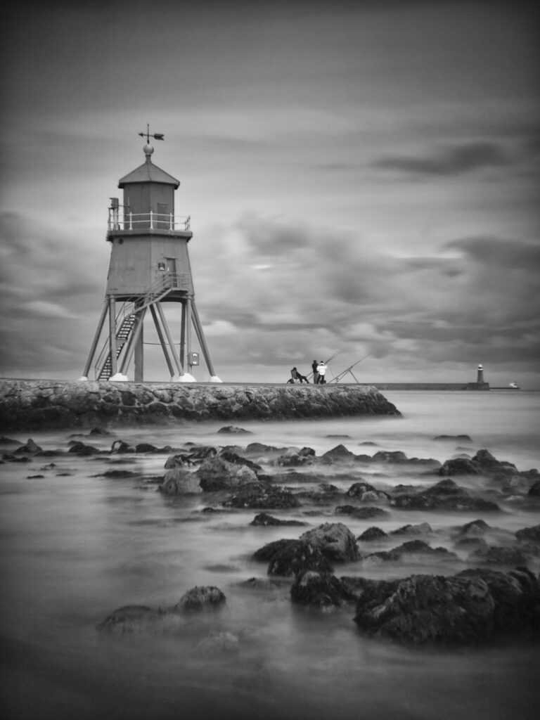 England, Tyne & Wear, South Shields. Little Haven Beach, looking towards the South Groyne Lighthouse.