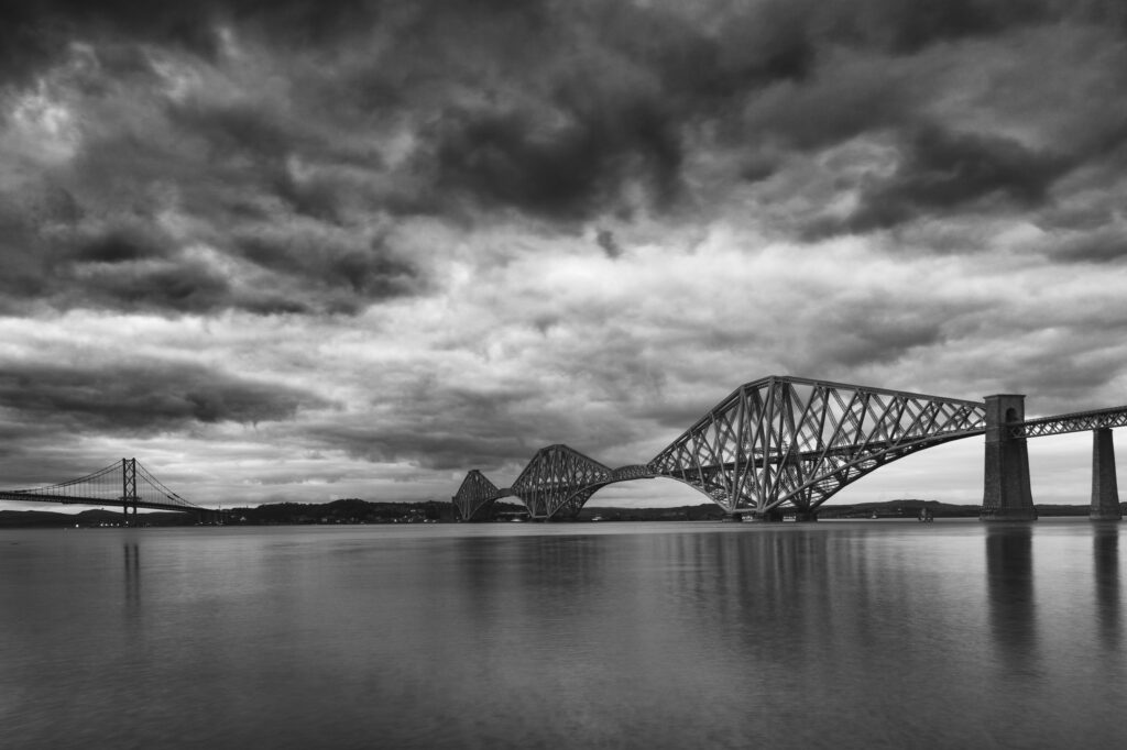 Scotland, Edinburgh, Forth Bridge. Forth Railway Bridge & Forth Road Bridge connecting Scotland's capital city, Edinburgh, with Fife, leaving the Lothians at Dalmeny and arriving in Fife at North Queensferry.