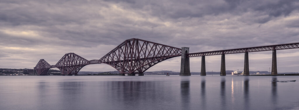 Scotland, Edinburgh, Forth Bridge. Forth Railway Bridge connecting Scotland's capital city, Edinburgh, with Fife, leaving the Lothians at Dalmeny and arriving in Fife at North Queensferry.