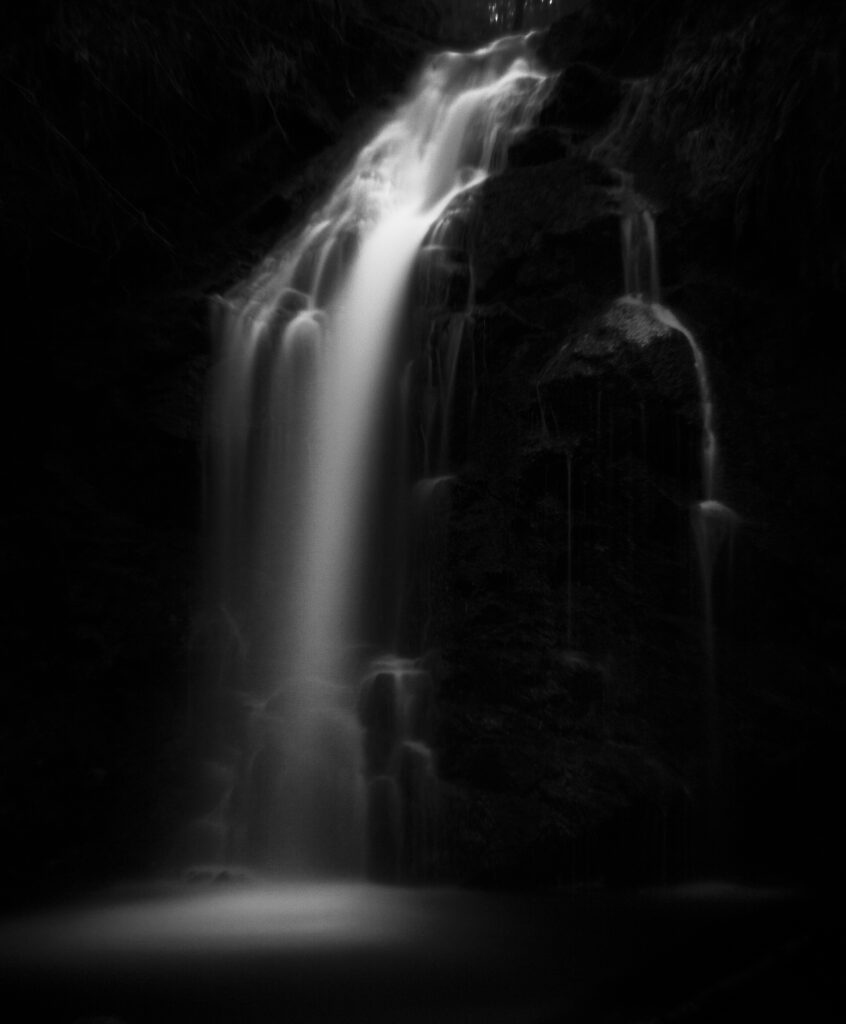 England, Northumberland, Hindhope Linn. Hindhope Linn, a cascade along the Blakehope Burn in the Kielder Forest Park near Blakehopeburnhaugh. Hindhope Linn is located near Bryness Vilage within the Northumberland National Park.