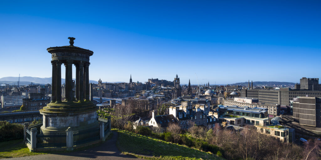 Scotland, Edinburgh, Calton Hill. The Dugald Stewart Monument on Calton Hill, looking towards the Castle and Old Town of Edinburgh.