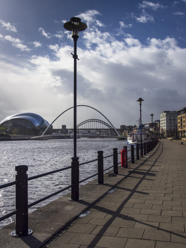 England, Tyne & Wear, Newcastle Upon Tyne. Snow shower on the Newcastle Quayside with the Sage Building, Millennium Bridge, Tyne Bridge and High Level Bridge in view.