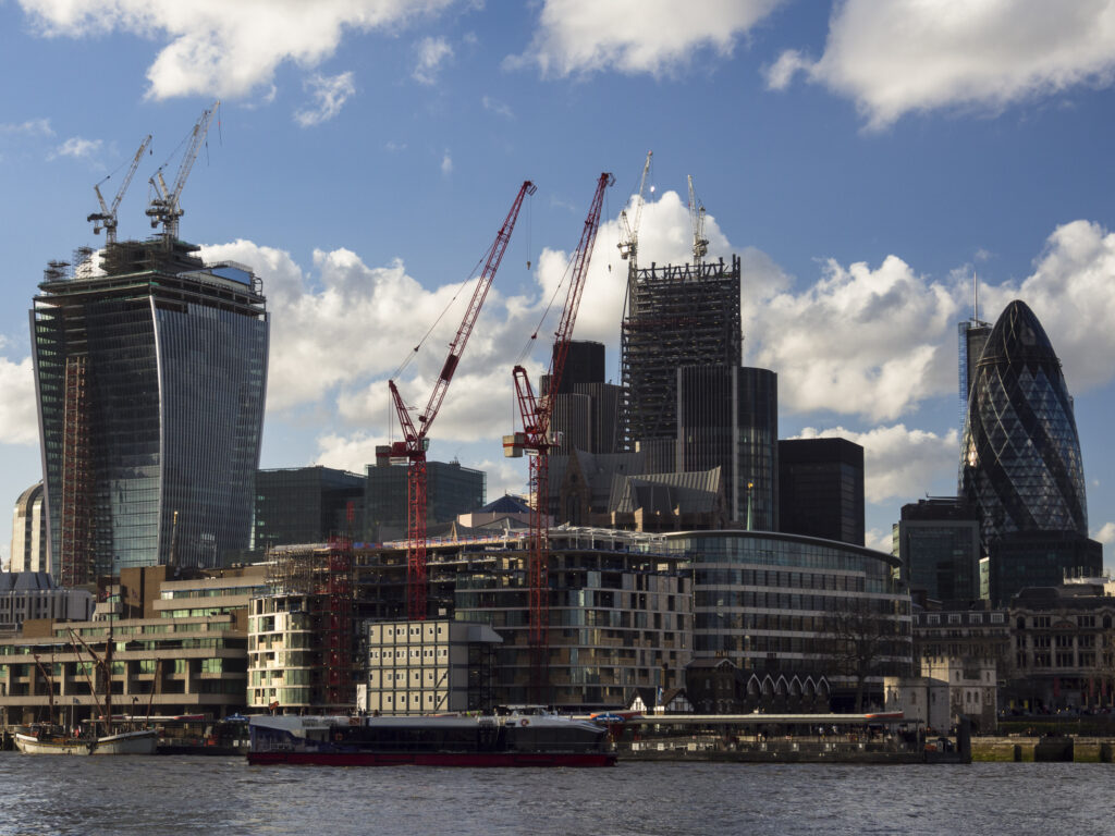 Portal Editing Team selected this image for Photodisc. Writings remove from cruise. England, Greater London, London City. Construction work in the financial district of the city of London, with the iconic Gherkin building in view.