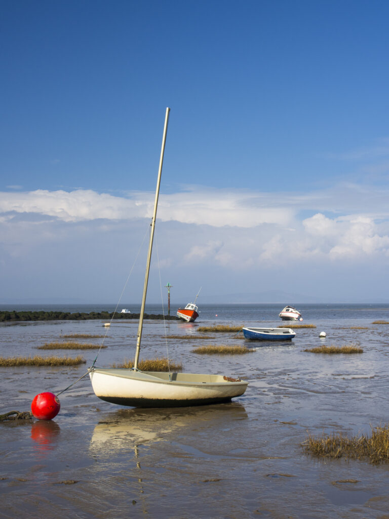 England, Lancashire, Morecambe. Fishing boats at low tide moored at Morecambe / Morecambe Bay.