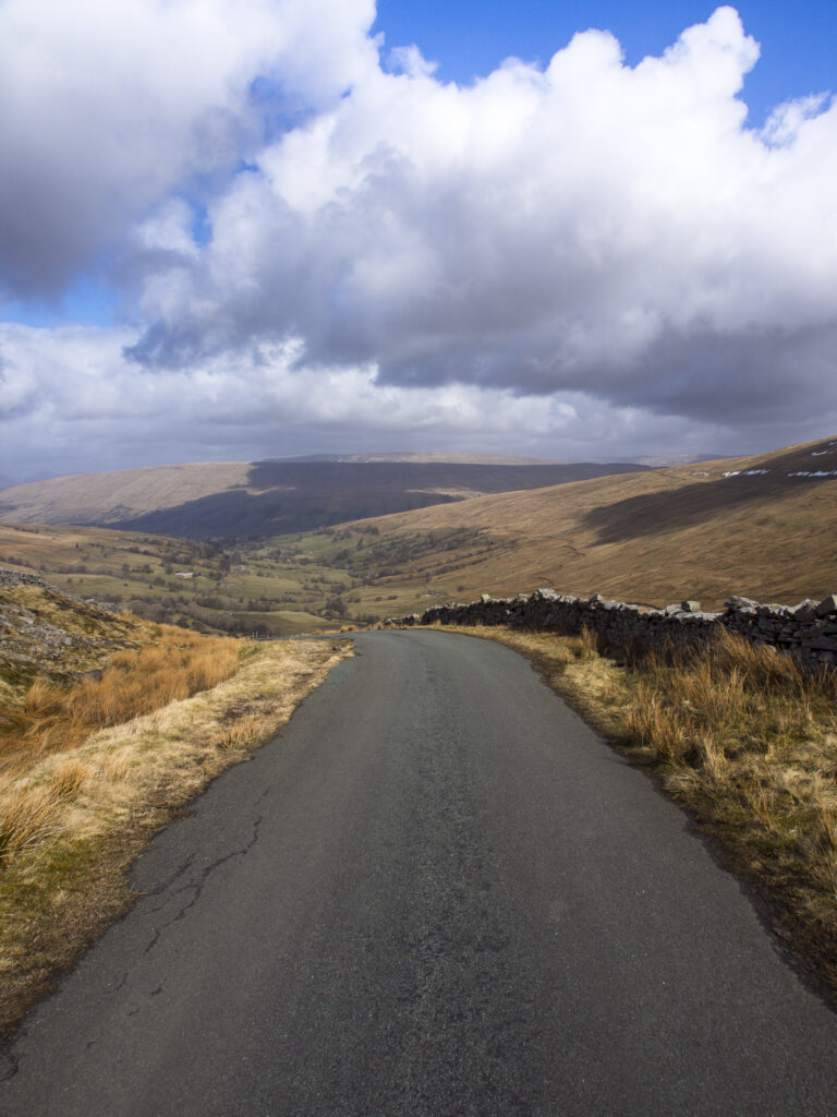 England, North Yorkshire, Yorkshire Dales National Park. Single track road running through Deepdale, a secluded valley in the Yorkshire Dales National Park near the village of Dent.