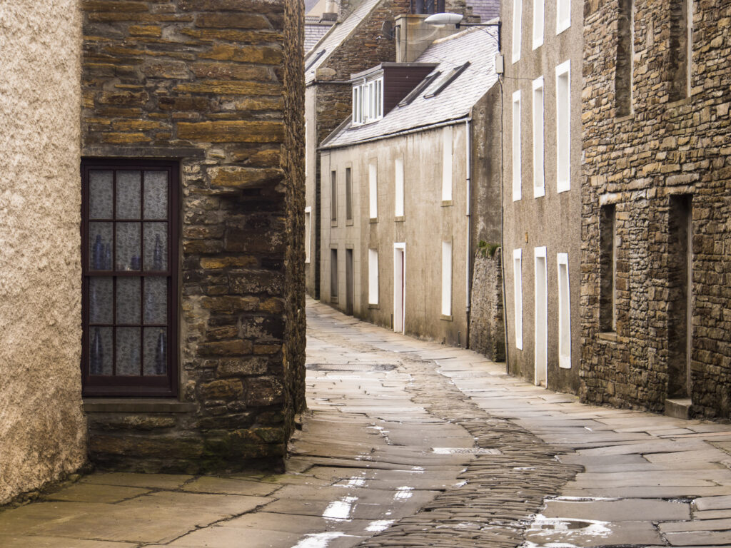 Scotland, Orkney Islands, Mainland Orkney. The cobbled winding main street of the old town of Stromness, the second most populated town in Orkney.
