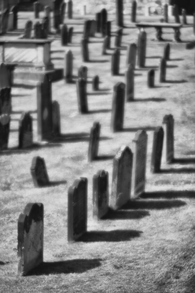 England, Tyne and Wear, Tynemouth Castle and Priory. Head stones in the graveyard of Tynemouth Priory.