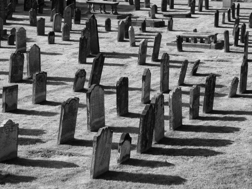 England, Tyne and Wear, Tynemouth Castle and Priory. Head stones in the graveyard of Tynemouth Priory.