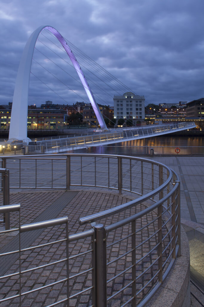 England, Tyne and Wear, Gateshead. The Gateshead Millennium Bridge, crossing the River Tyne towards the Malmaison hotel in the former cooperative building on the Newcastle Upon Tyne Quayside.
