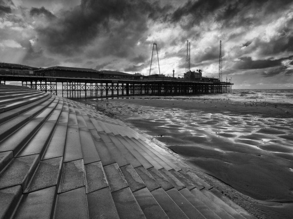 England, Lancashire, Blackpool. Storm clouds above Blackpool South Pier located near the Irish Sea in Lancashire.