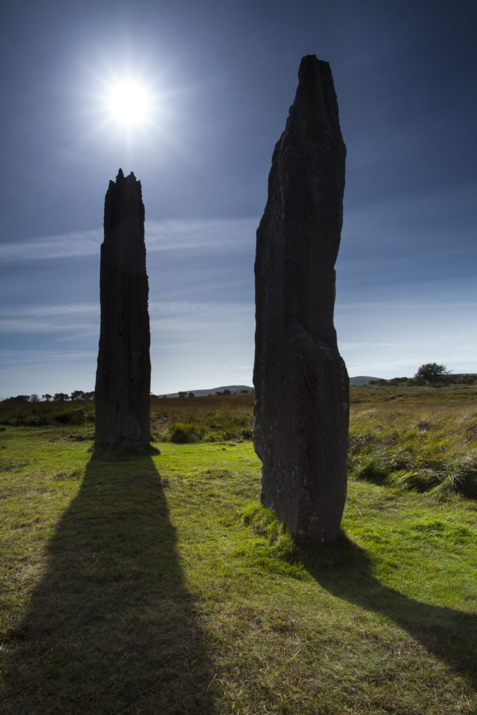 Scotland, North Ayrshire, Isle of Arran. Sun above a prehistoric stone circle on Machrie Moor, on the autumn equinox.