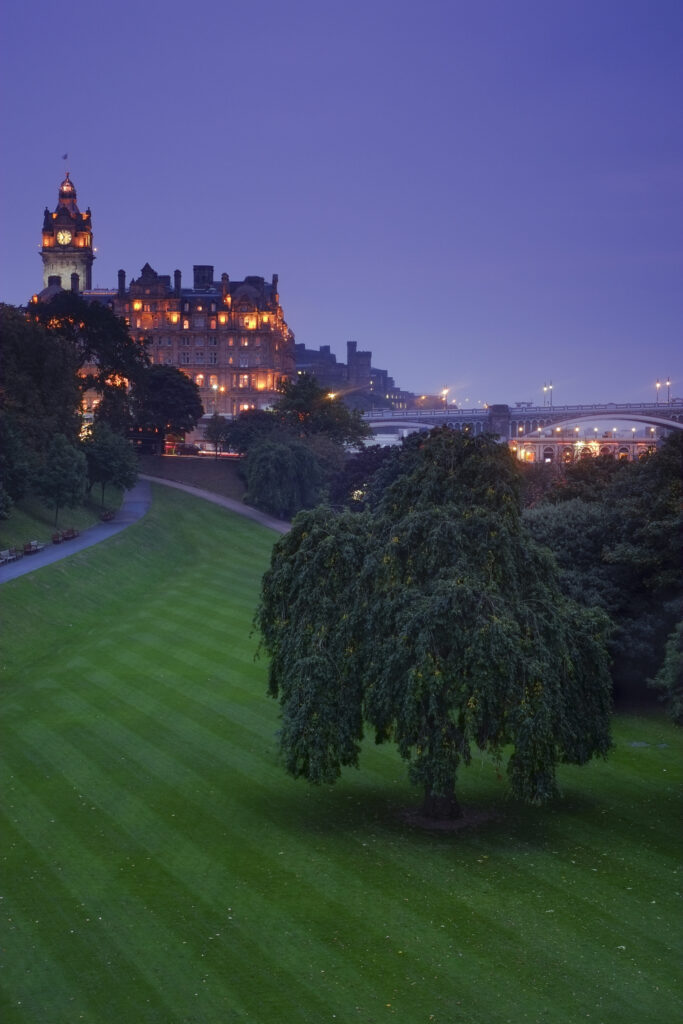 Scotland, Edinburgh, Princes Street Gardens. Princes Street Gardens looking towards Balmoral Hotel and clock tower with the North Bridge below.