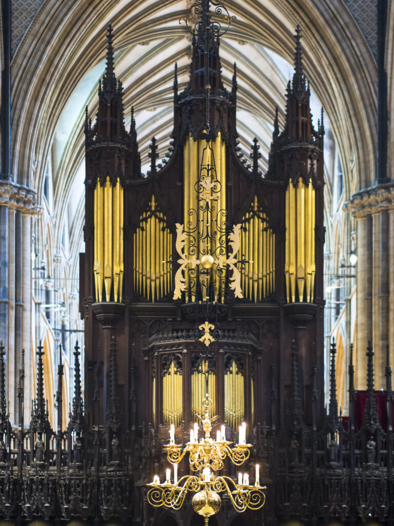 England, Lincolnshire, Lincoln Cathedral. Detail shot of the interior of Lincoln Cathedral featuring Organ Pipes and Candles.