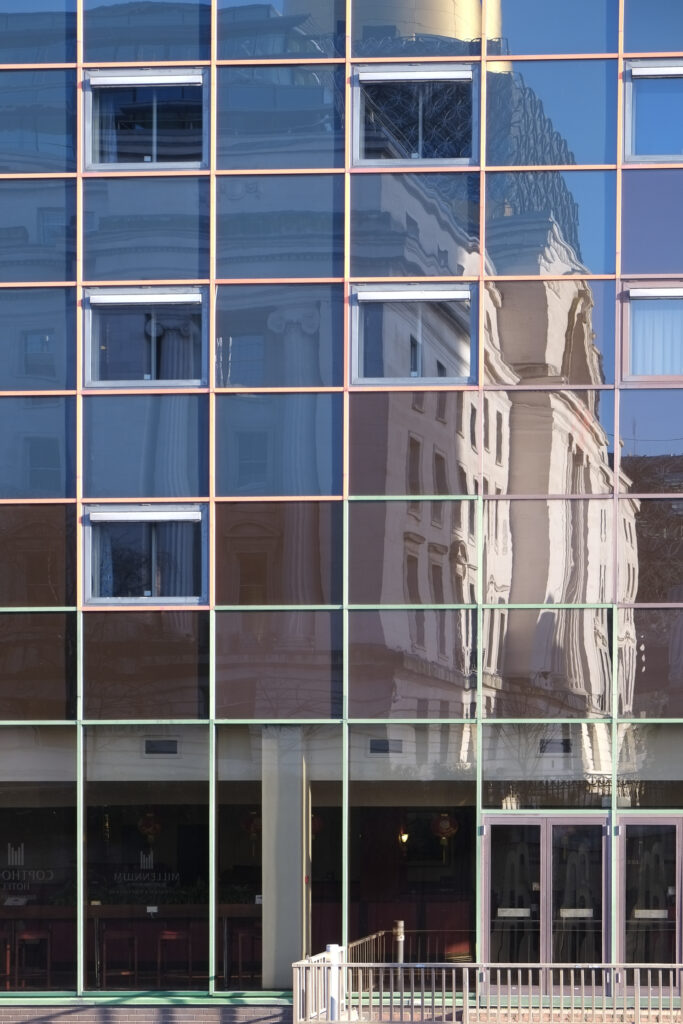 England, West Midlands, Birmingham City. Baskerville House in Centenary Square, reflected upon the modern facade of the Copthorne Hotel.