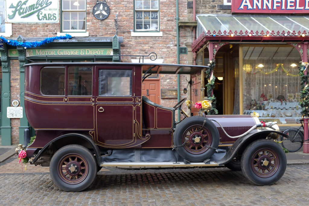 England, Tyne & Wear, Beamish Museum. Vintage car parked in a vintage street at the Beamish Museum, England, Tyne & Wear, Beamish Museum. Christmas decoraions on a tram at the Beamish Museum, a world famous museum telling the story of the people of North East England during the Georgian, Victorian, and Edwardian periods.