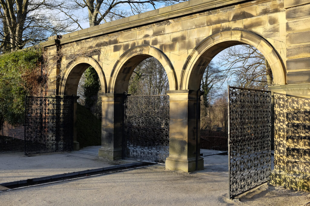 England, Northumberland, Alnwick Gardens. Stone archway and gates at the Alnwick Gardens near Alnwick Castle.