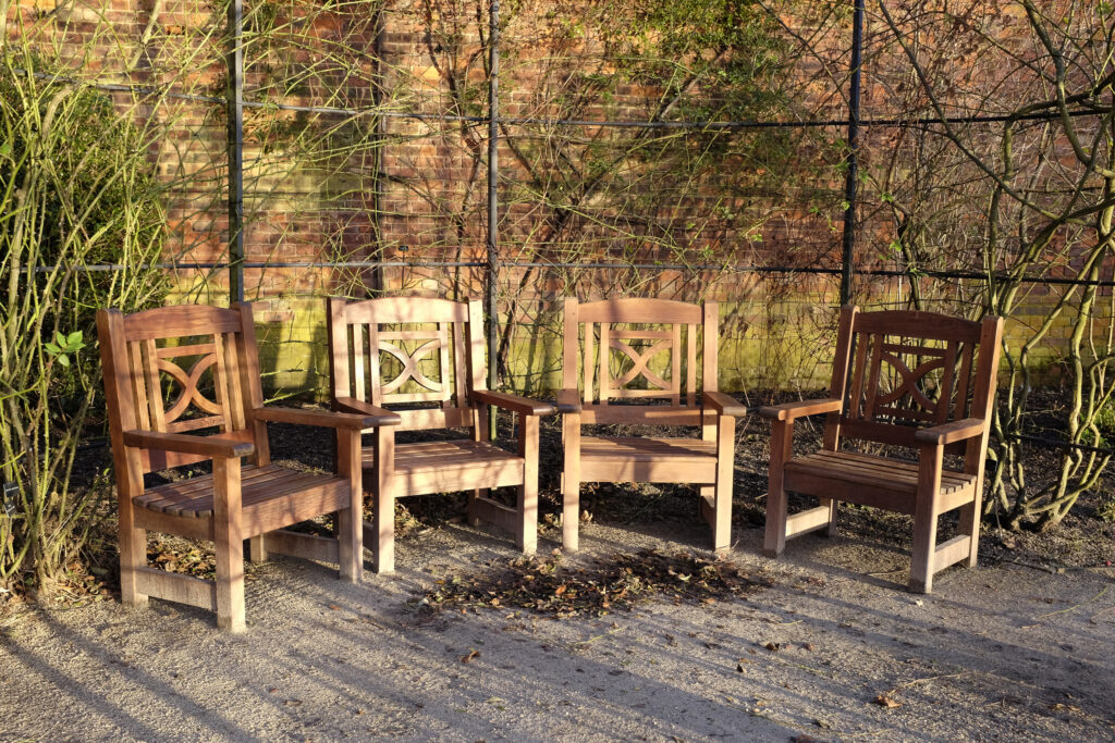 England, Northumberland, Alnwick Gardens. Wooden benches in the walled garden at the Alnwick Gardens.