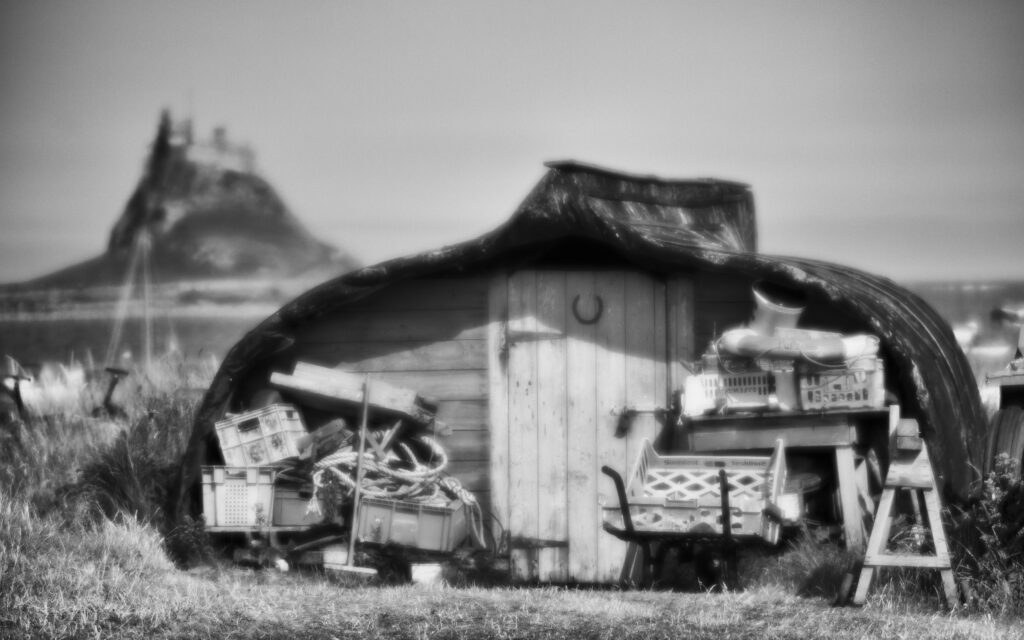 England, Northumberland, Lindisfarne / Holy Island. Upturned boat converted into a fishing hut on the Holy Island of Lindisfarne.