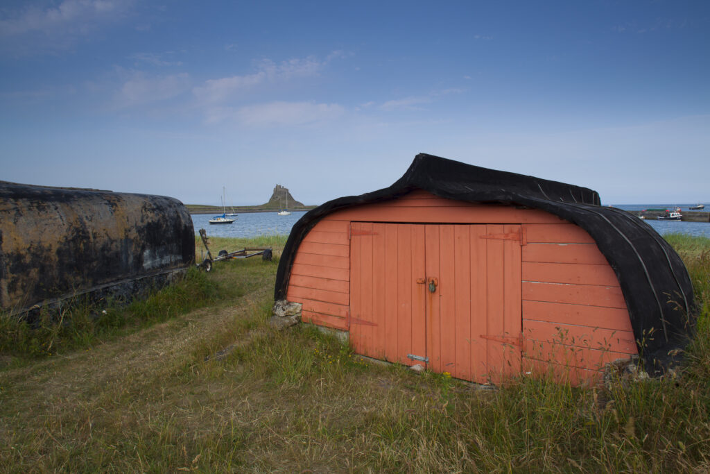 England, Northumberland, Lindisfarne / Holy Island. Upturned boat converted into a fishing hut on the Holy Island of Lindisfarne.