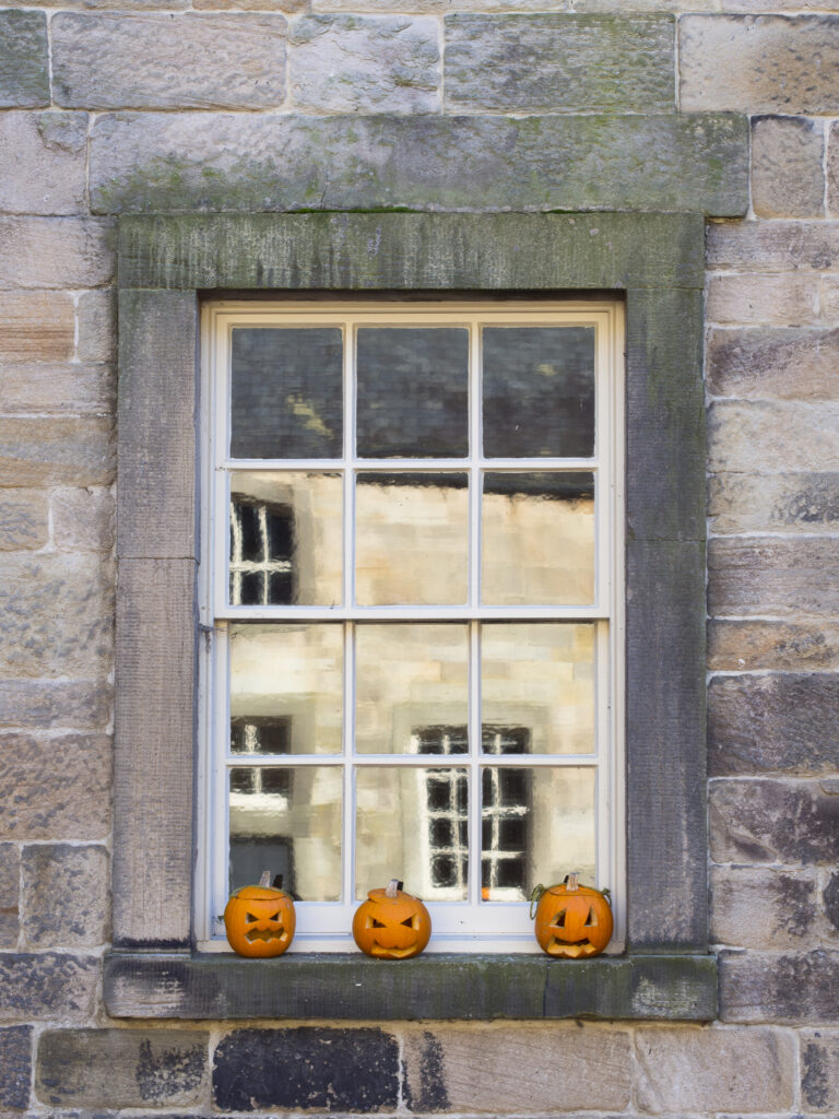 England, Tyne and Wear, Gibside Estate. Carved pumpkin on a window, part of the Halloween celebrations at the National Trust Gibside Estate.