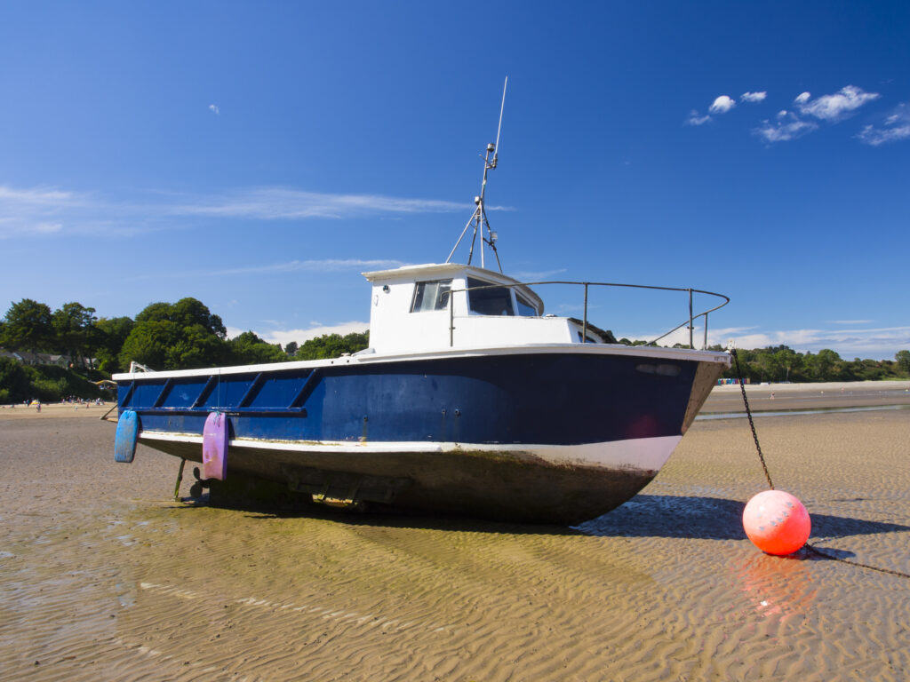 Wales, LLeyn Peninsula, Traeth Llanbedrog. Boat moored at low tide on Llanbedrog Beach on the LLeyn Peninsula.