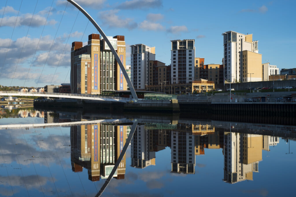 England, Tyne and Wear, Newcastle Quayside. The Baltic and nearby Gateshead apartments reflected in the River Tyne.