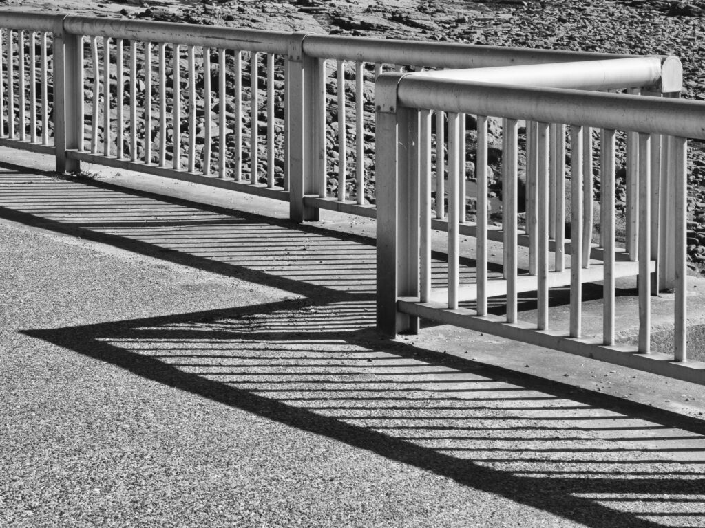 England, Tyne and Wear, Cullercoats. Shadow from metal fence near Cullercoats Bay, a popular coastal area on the North Tyneside Coast near Newcastle.