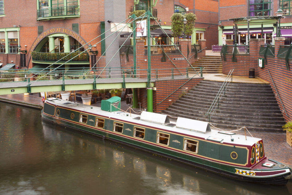 England, West Midlands, Birmingham City. Narrow boat moored on a canal at Brindley Place in Birmingham City. -- Portal Editing Team selected this image for Photolibrary RM.