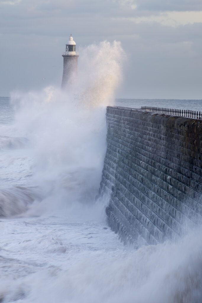 England, Tyne and Wear, Tynemouth. Waves crash at the mouth of the River Tyne, during a winter storm.