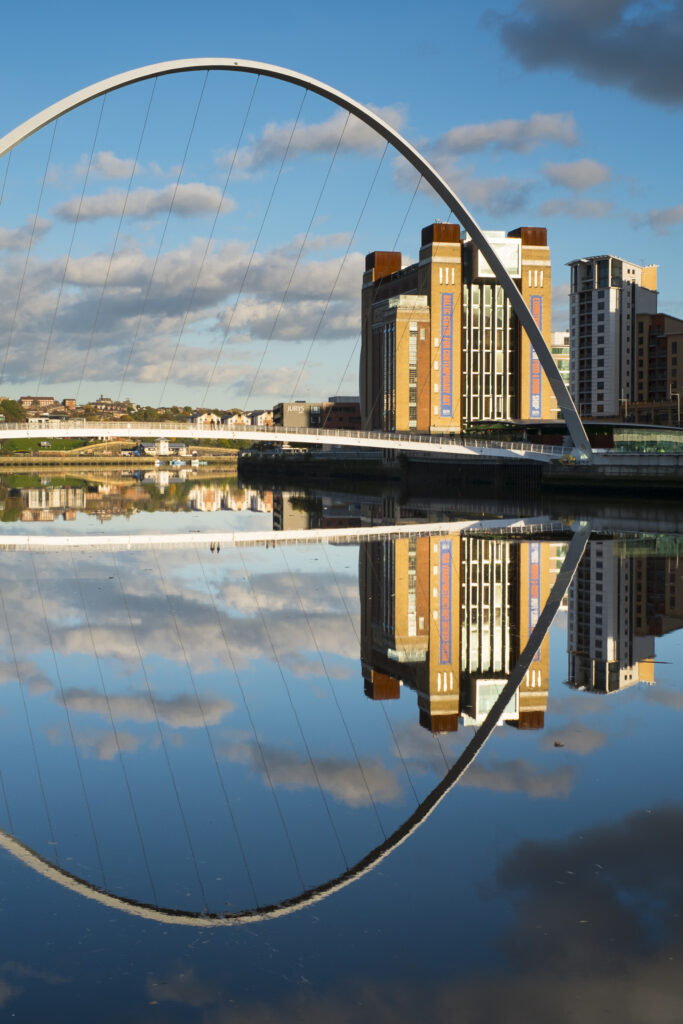 England, Tyne and Wear, Newcastle Upon Tyne. The Baltic Gallery in Gateshead, with the Millennium Bridge crossing the River Tyne.