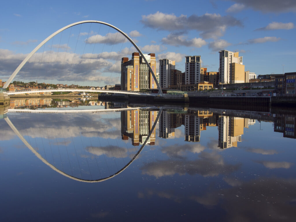 England, Tyne and Wear, Newcastle Upon Tyne. The Baltic Gallery in Gateshead, with the Millennium Bridge crossing the River Tyne.
