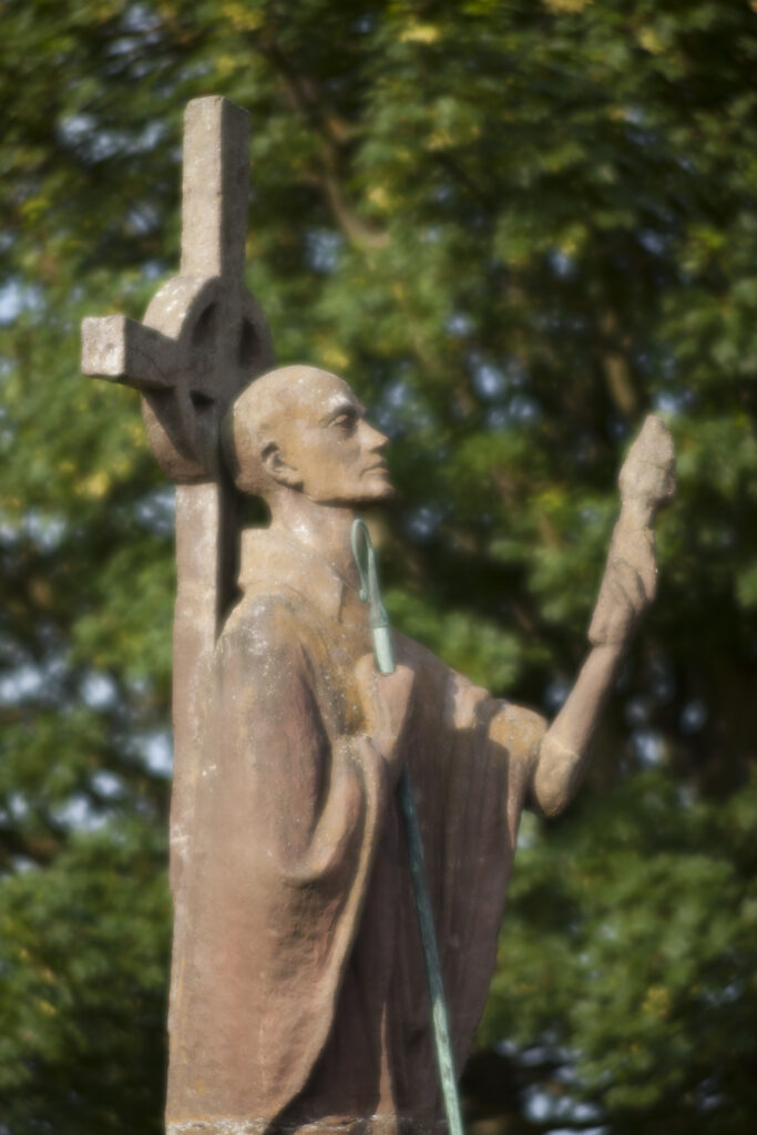 England, Northumberland, Lindisfarne / Holy Island. Statue of St. Aidan in the grounds of the Lindisfarne Priory, located upon Holy Island along the Northumberland Heritage Coast.