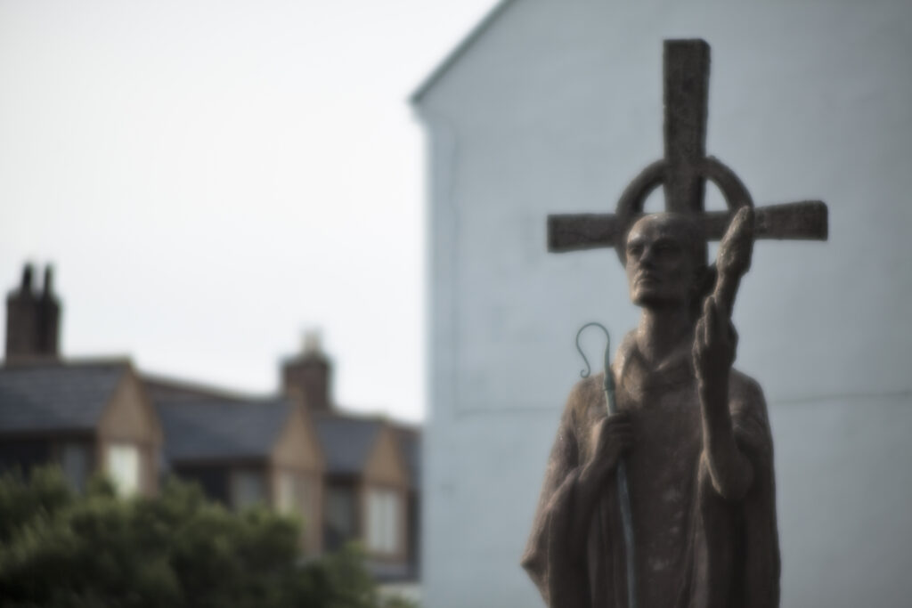 England, Northumberland, Lindisfarne / Holy Island. Statue of St. Aidan in the grounds of the Lindisfarne Priory, located upon Holy Island along the Northumberland Heritage Coast.