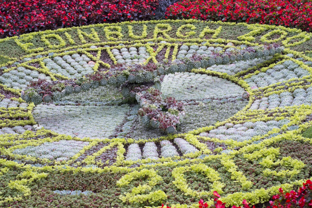 Scotland, Edinburgh, Princes Street Gardens. The world's oldest floral clock, and a flower display celebrating 100 years of the Edinburgh Zoo.
