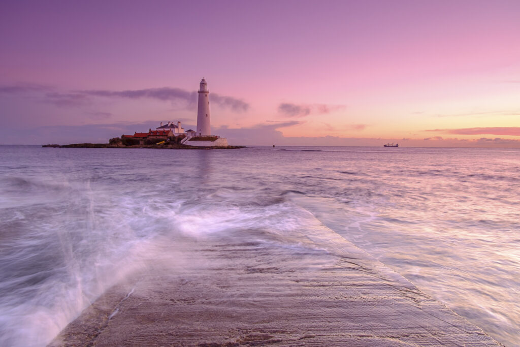 England, Tyne and Wear, Whitley Bay. Incoming tide engulfs the causeway linking St Mary's Island & lighthouse to the mainland.