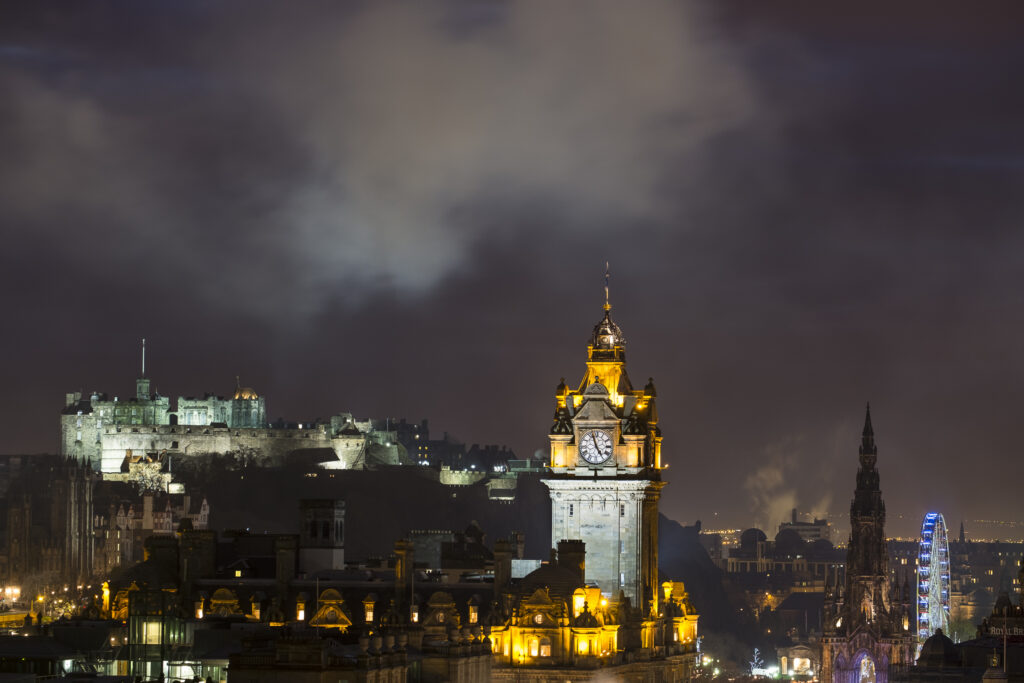 Scotland, Edinburgh, City Skyline. Smoke above the impressive skyline of Edinburgh City viewed from Calton Hill looking towards Castle Rock and the surrounding old town.