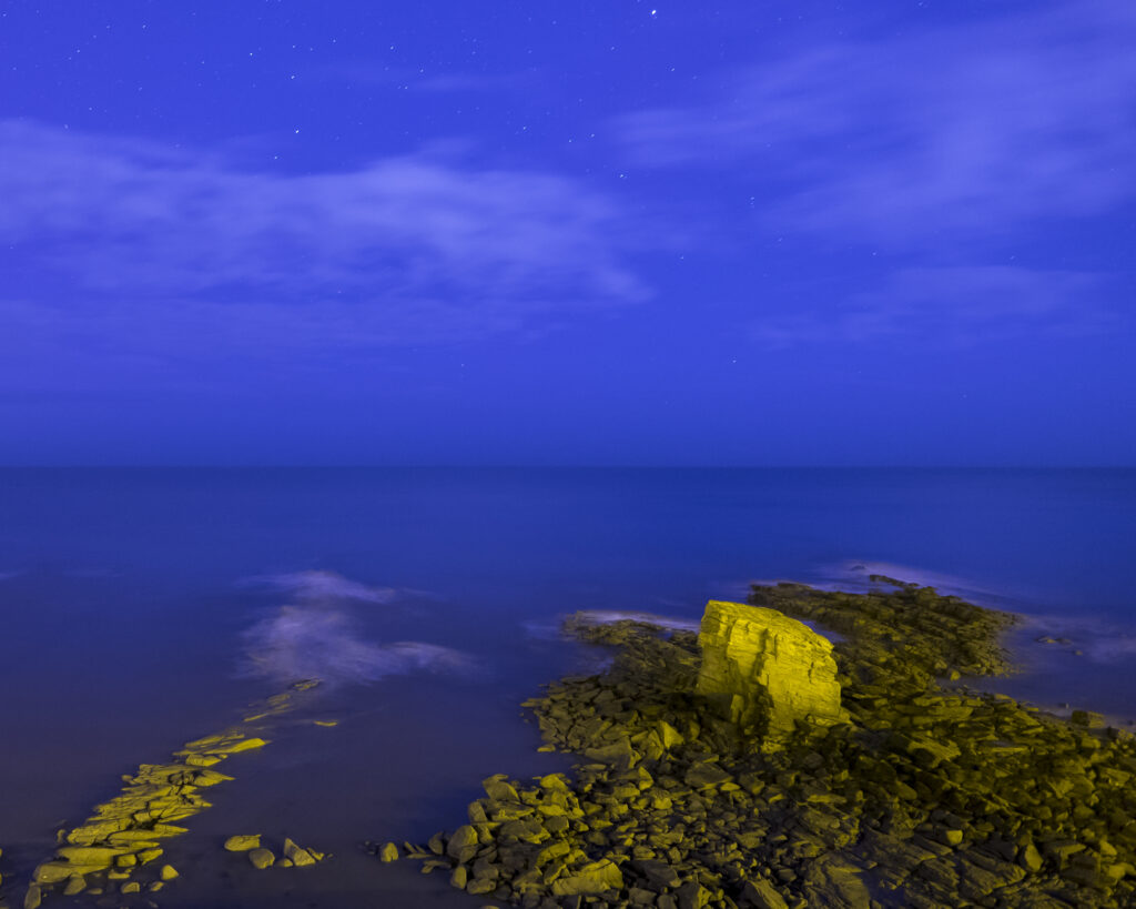 England, Northumberland, Seaton Sluice. Night time scene of Charlies Garden, a rock formation located in Collywell Bay, Seaton Sluice.
