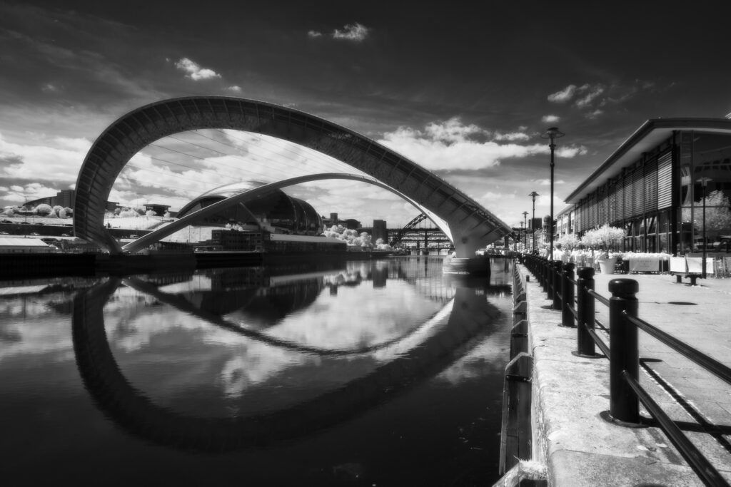 England, Tyne and Wear, Newcastle Quayside. The Gateshead Millennium Bridge, a pedestrian and cyclist tilt bridge spanning the River Tyne in England between Gateshead and Newcastle.