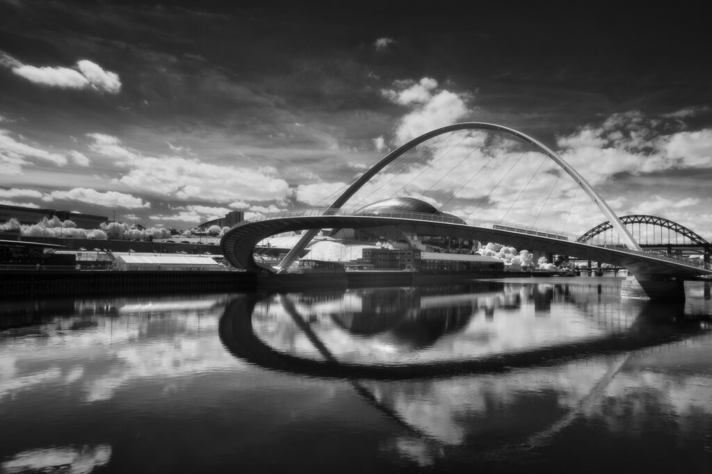 England, Tyne and Wear, Newcastle Quayside. The Gateshead Millennium Bridge, a pedestrian and cyclist tilt bridge spanning the River Tyne in England between Gateshead and Newcastle.