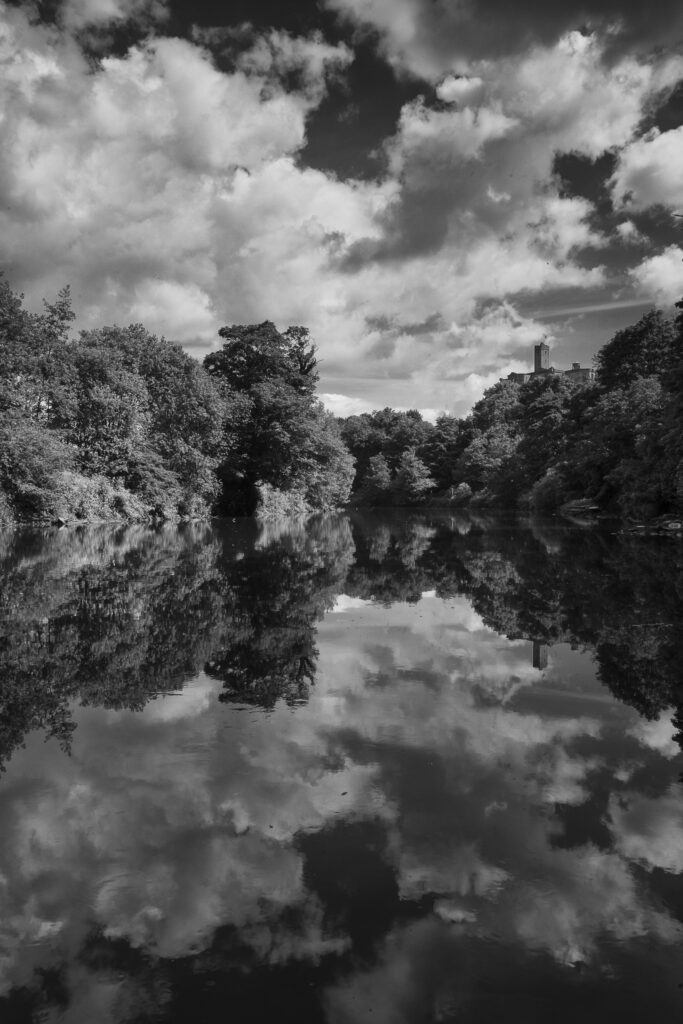 England, Northumberland, Warkworth. Warkworth Castle reflected upon the still waters of the River Coquet.