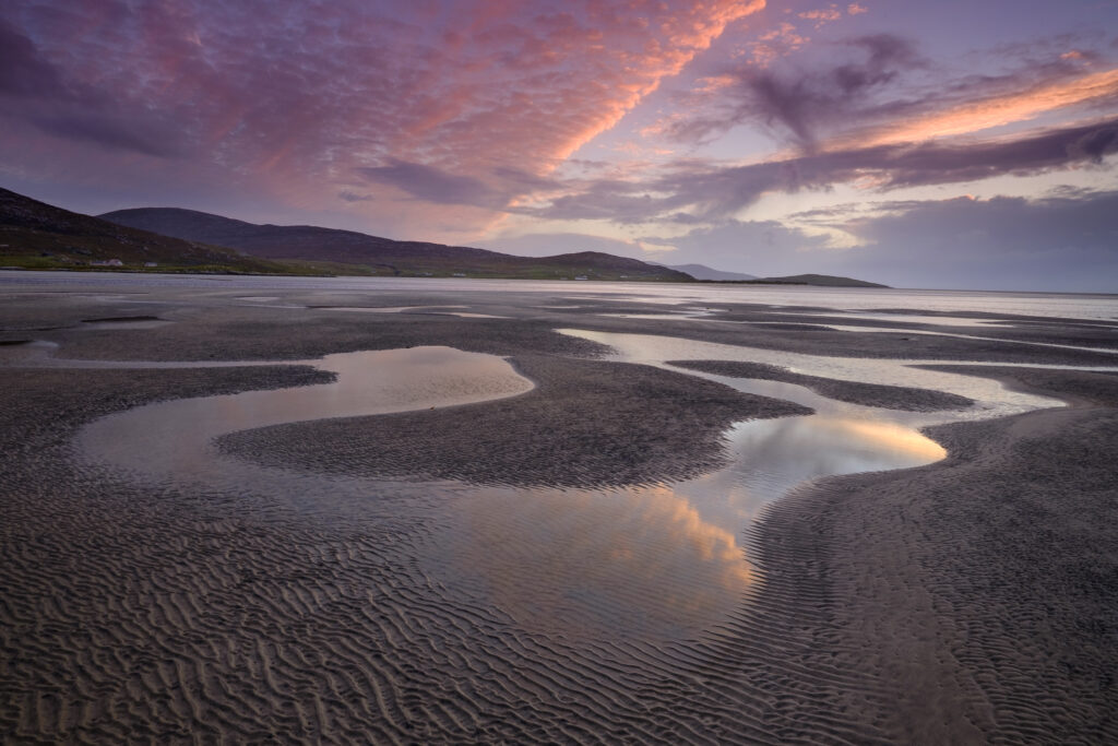 Scotland, The Isle of Harris, Seilebost. Sunset over the Lusketyre Bay on the Luskentyre peninsula looking towards Seilebost.