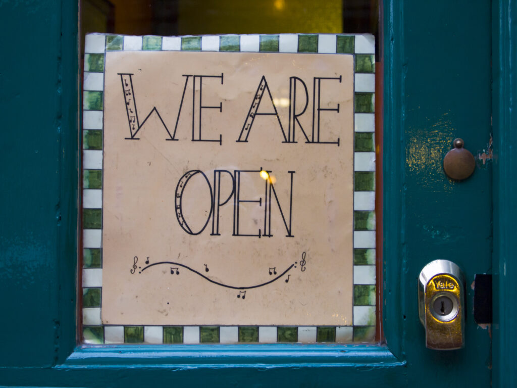 England, North Yorkshire, York. We are open sign on a shop in the city of York.
