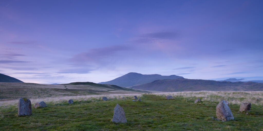 England, Cumbria, Lake District National Park. Stone circle forming part of Burnmoor Complex located on a fellside at the foothills of the mountains known as Scafell and Scafell Pike.