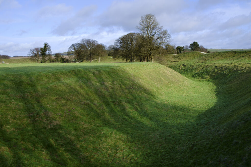 England, Wiltshire, Stonehenge & Avebury World Heritage Site (WHS). Avebury Henge looking towards the prehistoric standing stones of the Avebury Stone Circle.